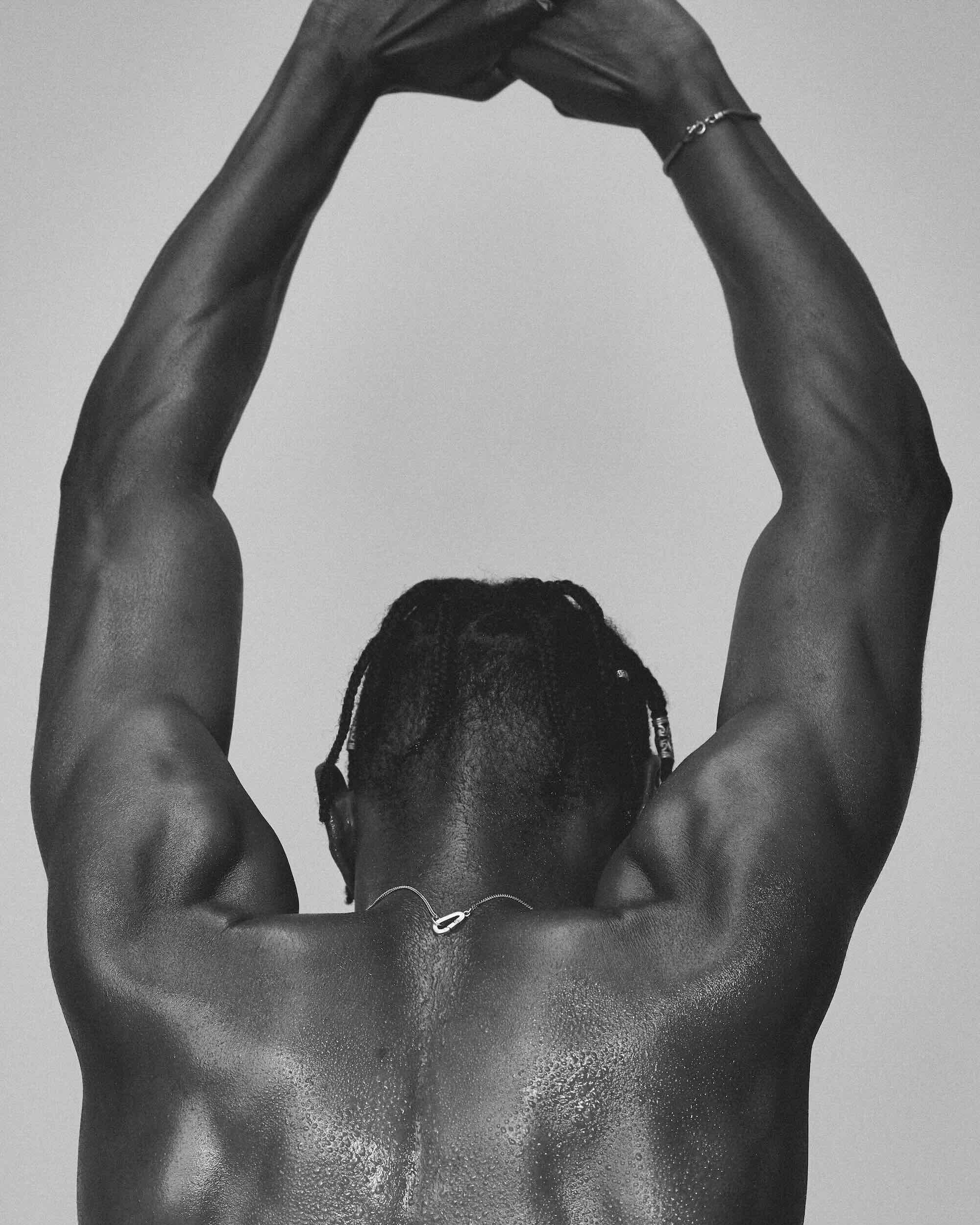 Person with arms raised against a plain background