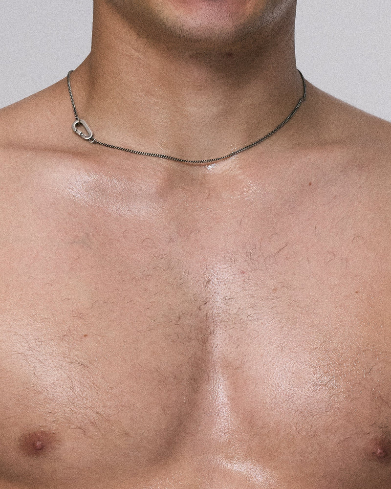 Man with a shirtless torso against a plain background