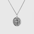 Silver compass pendant necklace on a light gray background 925 silver neckace