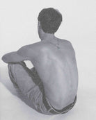 Person sitting on a white background with a minimalistic approach