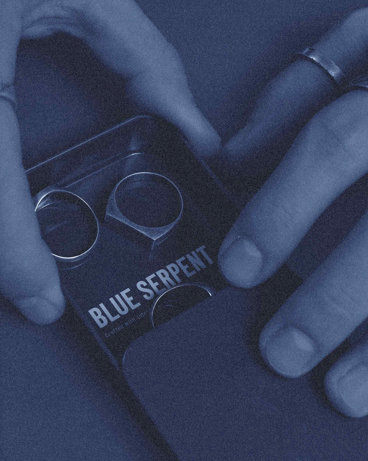 Person holding a small black box with 'Blue Serpent' branding